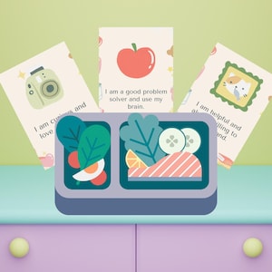 May include: Three affirmation cards with colorful illustrations and text. The cards are placed on a light blue surface with a purple drawer below. The text on the cards reads: "I am curious and love", "I am a good problem solver and use my brain", and "I am helpful and willing to learn."