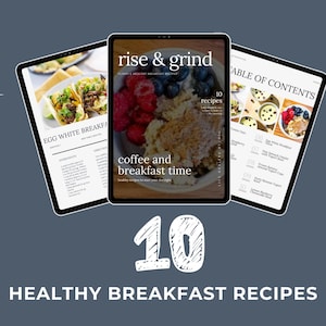 May include: Three tablets displaying a digital cookbook with healthy breakfast recipes. The central tablet shows a bowl of oatmeal with berries. The text reads "rise & grind" and "coffee and breakfast time". The bottom of the image reads "10 HEALTHY BREAKFAST RECIPES".