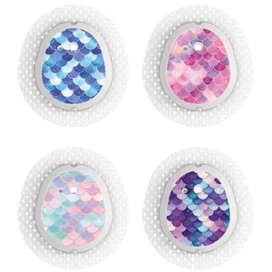 May include: Four round adhesive bandages with different mermaid scale designs. The designs are blue, pink, purple, and a combination of blue, pink, and purple.