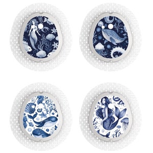 May include: Four medical device covers with blue and white ocean designs. Each cover features a different illustration: a mermaid, a whale, a stingray, and a mermaid with jellyfish. The covers have a white, textured border.
