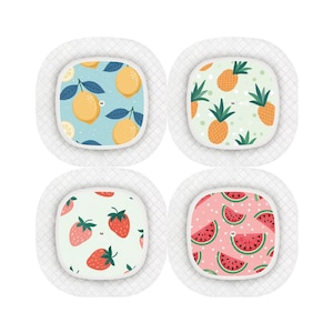 May include: Four white round adhesive bandages with different fruit patterns. The bandages feature lemons, pineapples, strawberries, and watermelons.