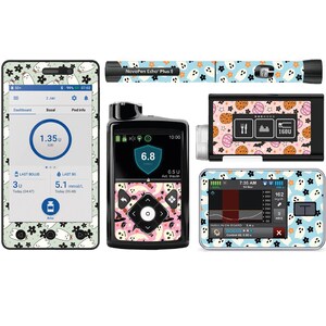 Könnte beinhalten: Eine Sammlung medizinischer Geräte, darunter ein Smartphone, ein Insulin-Pen und eine Insulinpumpe, alle mit passenden dekorativen Skins versehen. Die Skins zeigen ein Muster aus Geistern, Blumen und Halloween-Elementen auf hellblauem Hintergrund.