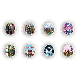 May include: Eight round, white, adhesive bandages with colorful, printed designs featuring characters and scenes from the popular online game Roblox. The designs include a character wearing a black uniform, a group of characters in a futuristic setting, a character holding a sword, a character in a pink and purple setting, a character in a blue and green setting, a character in a blue and white setting, a character in a pink and yellow setting, and a character in a green and brown setting.
