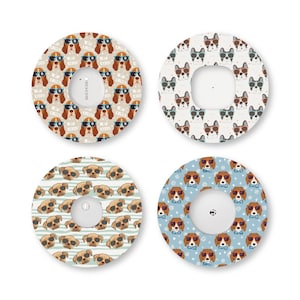 May include: Four circular adhesive patches for medical sensors, each featuring a repeating pattern of dogs wearing sunglasses. The designs include brown hounds on tan, French bulldogs on white, tan puppies on striped blue, and hounds on light blue.