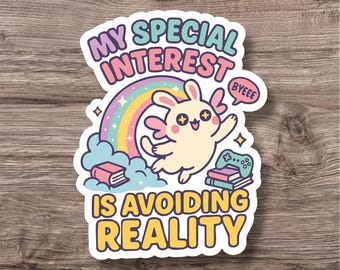 May include: A colorful sticker with the text "MY SPECIAL INTEREST IS AVOIDING REALITY". The design features a cartoon bunny with wings, a rainbow, books, and a game controller. The word "BYEEE" is in a speech bubble.