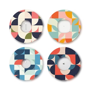 May include: Four circular adhesive patches for medical devices, each featuring a distinct geometric pattern. The designs include combinations of navy, coral, cream, olive, yellow, and light blue shapes arranged in repeating semi-circles and squares.