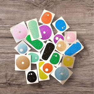 May include: Assortment of colourful glitter stickers in various shapes and sizes. The stickers are perfect for adding a touch of sparkle to any project.