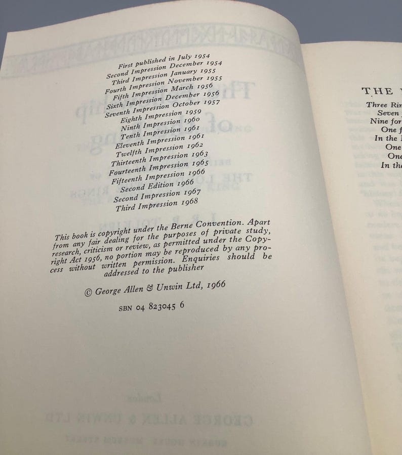 Puede incluir: P&aacute;ginas de libro abierto con texto que detalla la historia de la publicaci&oacute;n, incluyendo m&uacute;ltiples impresiones y ediciones de 1954 a 1968. Tambi&eacute;n se ve informaci&oacute;n de derechos de autor y detalles del editor. El libro est&aacute; abierto sobre una superficie azul.