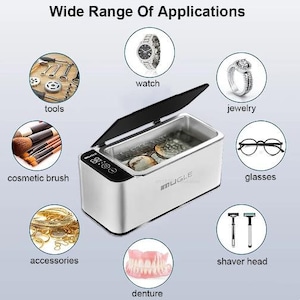 May include: A white ultrasonic cleaner with a digital display and a black lid. The cleaner is shown with various items that can be cleaned, including a watch, jewellery, glasses, a toothbrush, a denture, and a set of tools. The text "Wide Range Of Applications" is displayed at the top of the image.