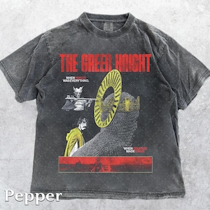 May include: Pepper-colored t-shirt featuring the text "THE GREEN KNIGHT" in red. The graphic includes illustrations of a knight, a crown, and text that reads "WHEN HONOR WAS EVERYTHING" and "WHEN COURAGE MADE KINGS".