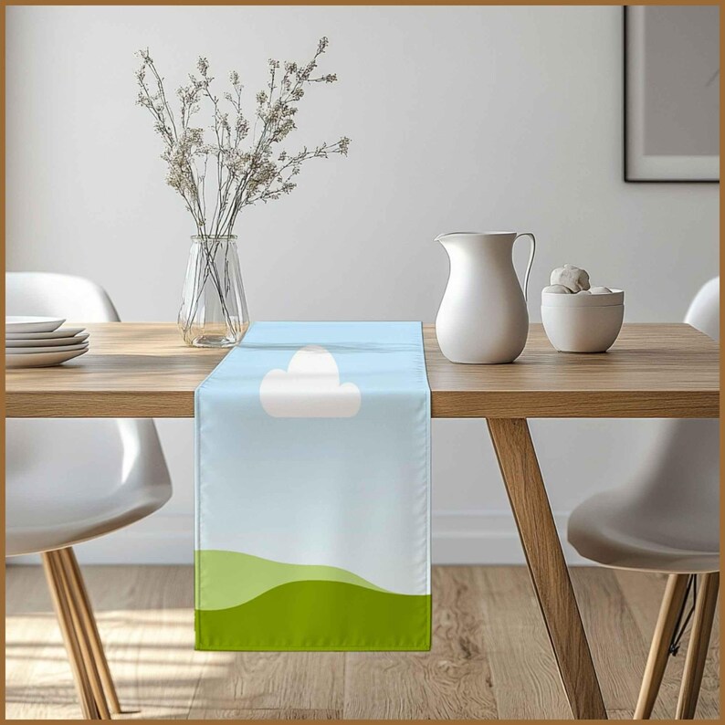 May include: A blue and green table runner with a white cloud design. The runner is on a wooden table with a vase of flowers and a white pitcher.