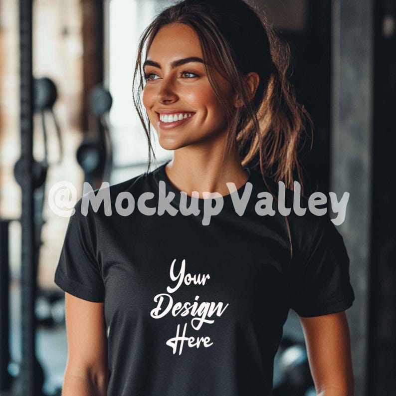 May include: A woman wearing a black t-shirt with the text "Your Design Here" printed on the front. The shirt is a mockup for a design.