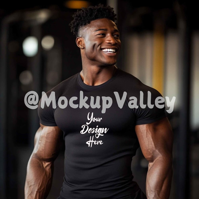May include: A black t-shirt with the text "Your Design Here" on the front. The shirt is being worn by a person with a muscular build. The background is blurry and appears to be a gym.