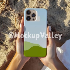 May include: A light blue phone case with a green and white landscape design. The case has a camera cutout and is being held by a person's hands.