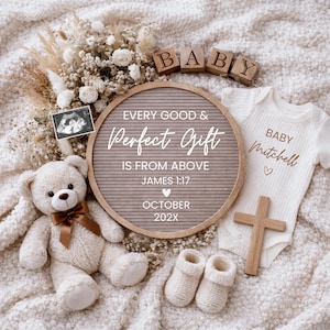 May include: A neutral-toned baby announcement featuring a teddy bear, ultrasound image, letter board with text, baby clothes, wooden cross, and blocks spelling "BABY". The letter board reads "EVERY GOOD & Perfect Gift IS FROM ABOVE".
