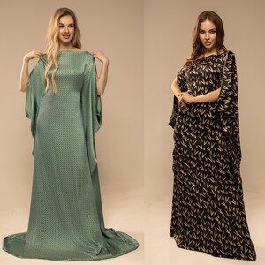May include: Two women wearing long, flowing dresses. The dress on the left is a light green with a subtle geometric pattern. The dress on the right is black with a gold pattern of repeating V shapes.