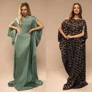 May include: Two women wearing long, flowing dresses with different patterns. The dress on the left is a teal green with a geometric pattern, while the dress on the right is black with a brown pattern of stylised Vs.