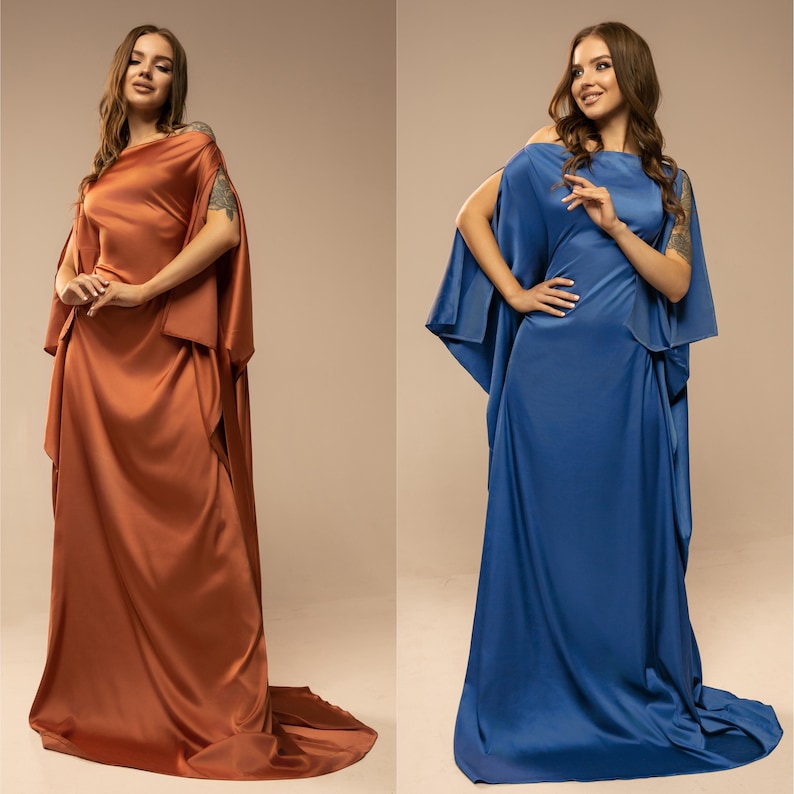 May include: Two women wearing long, flowing dresses. The dress on the left is rust coloured, and the dress on the right is a deep blue.
