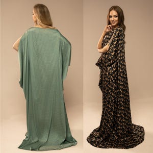 May include: Two women wearing long, flowing gowns. The gown on the left is a light green with a geometric pattern. The gown on the right is black with a gold pattern of stylised Vs.