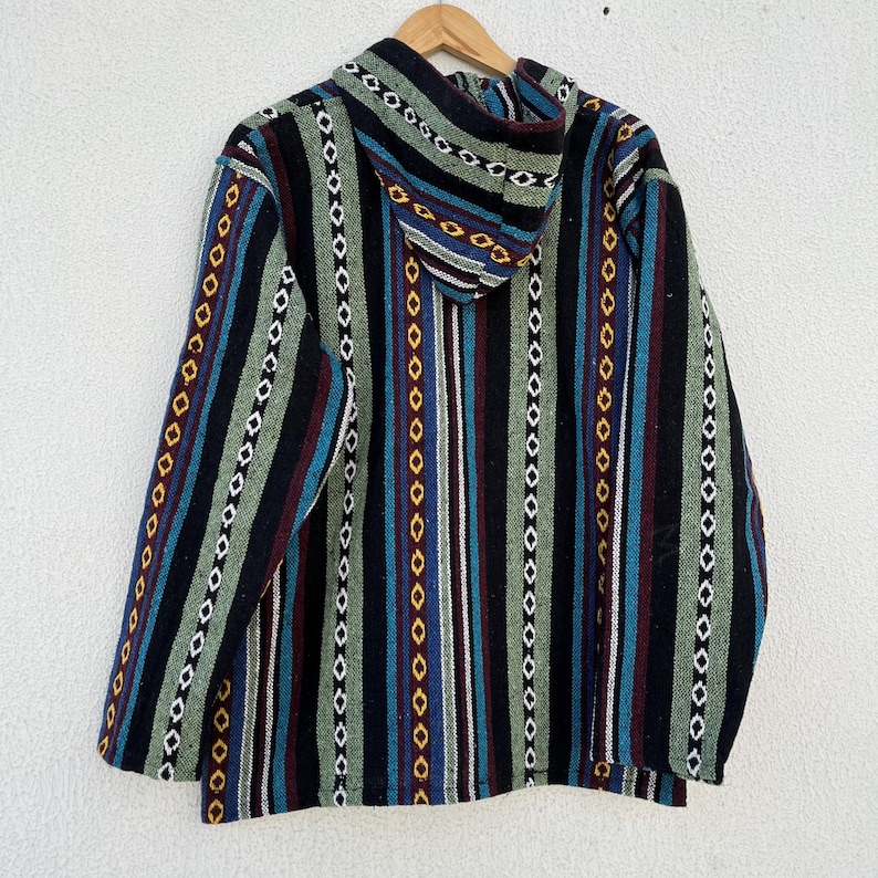 May include: A hooded jacket with a colorful striped pattern. The jacket features vertical stripes in black, green, blue, red, and yellow. The hood is visible at the top, and the jacket is hanging on a wooden hanger.