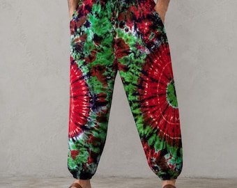 May include: Tie-dye pants in a vibrant red, green, and black spiral pattern. The pants have an elastic waistband and pockets. The loose-fitting pants are a comfortable style.