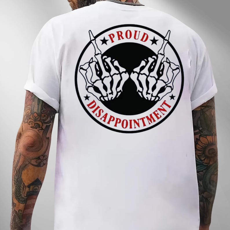 May include: White t-shirt featuring a black and red graphic on the back. The graphic is a circle with the words "PROUD" and "DISAPPOINTMENT" around two skeleton hands giving the middle finger.