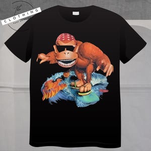 a t - shirt with a picture of a monkey riding a skateboard
