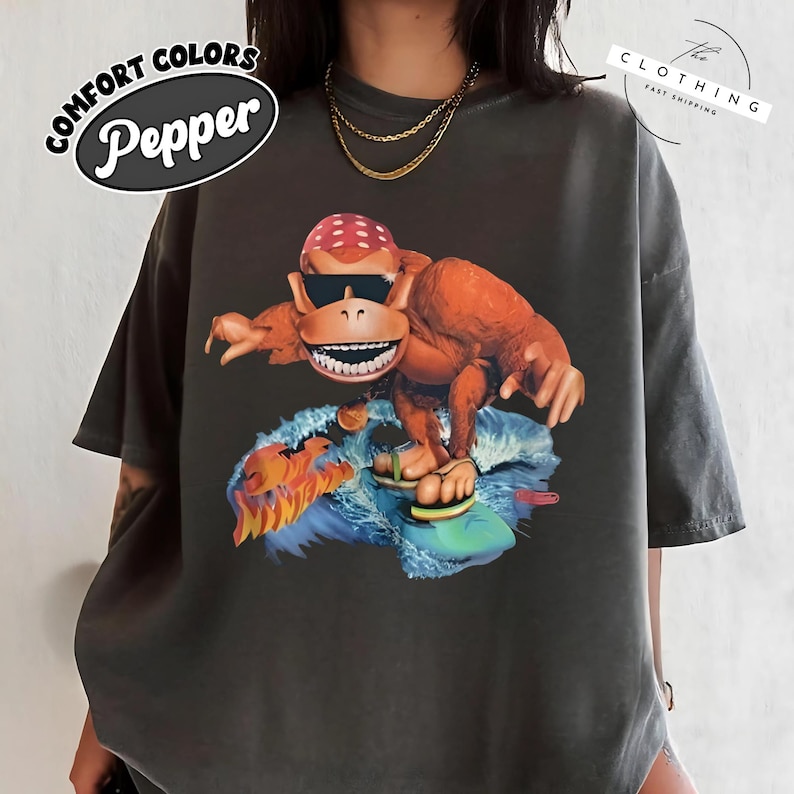 a woman wearing a black shirt with a monkey on it