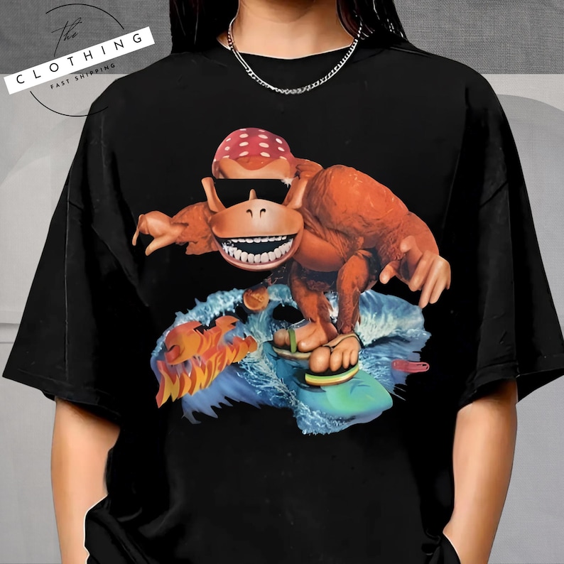 a woman wearing a black shirt with a picture of a dinosaur on it