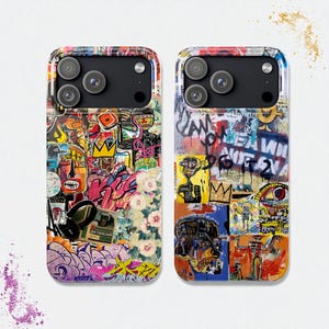 May include: Two phone cases with a colorful graffiti art design. The cases feature a collage of abstract faces, crowns, and text in various colors, including pink, yellow, and blue. The cases have a glossy finish and a black camera module.