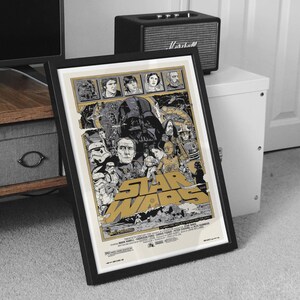 May include: Framed Star Wars movie poster. The poster features a collage of characters and scenes from the film, with the title in large, gold lettering. The poster is in a black frame.