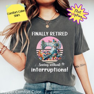 May include: A gray t-shirt with the text "FINALLY RETIRED" and a vintage-style illustration of a sewing machine with the text "Sewing without interruptions!"