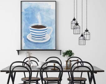May include: A framed art print of a coffee cup with blue and white stripes, set against a blue watercolor background. The print hangs above a dark wood dining table with black chairs. Decorative pendant lights hang above the table.