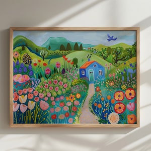 May include: A framed painting of a blue house with a white door in a field of colorful flowers. The house is surrounded by green hills and a blue sky. There is a small bird flying in the sky.