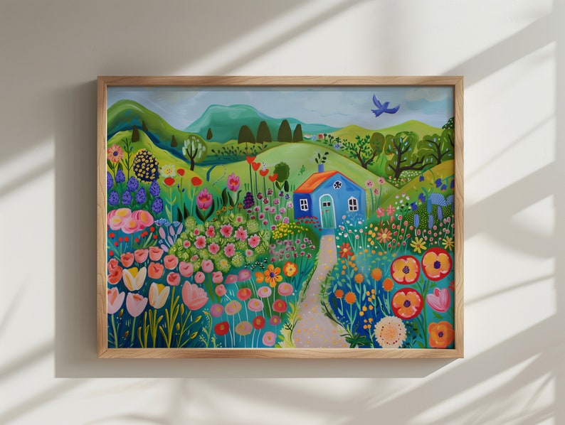 May include: A framed painting of a blue house with a white door in a field of colorful flowers. The house is surrounded by green hills and a blue sky. There is a small bird flying in the sky.