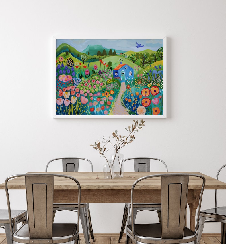 May include: A painting of a blue house with a green roof in a field of colorful flowers. The house is surrounded by green trees and hills. A blue bird flies overhead.