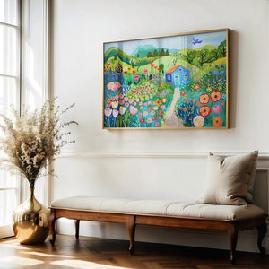May include: A colorful painting of a blue house in a field of flowers. The house has a white door and a red roof. The flowers are in shades of pink, red, yellow, and blue. The painting is framed in gold.