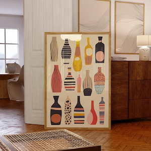 May include: A framed art print featuring a collection of stylized bottle illustrations in various shapes, colors, and patterns. The bottles are set against a cream background, with a wooden frame. The color palette includes black, yellow, pink, and blue.