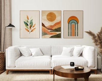 May include: Three framed abstract art prints in a minimalist style. The prints feature a green and orange leaf, a landscape with a sun and mountains, and a rainbow arch with a sun.