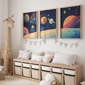 May include: Three framed prints depicting colourful planets and stars against a dark blue backdrop. The prints are hung on a white wall above a wooden bench with storage compartments.
