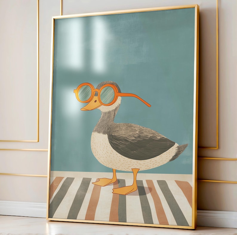 May include: Framed art print featuring a whimsical illustration of a duck wearing orange-rimmed glasses. The duck has gray and white feathers, orange feet, and a yellow beak. The background is a teal color with a striped rug.