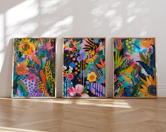 May include: Three framed prints with colorful abstract floral designs. The prints feature a variety of flowers, leaves, and geometric patterns in shades of pink, blue, green, yellow, and orange.