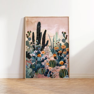 Pu&ograve; includere: Una stampa incorniciata di un paesaggio desertico con cactus e fiori in tonalit&agrave; di verde, blu, arancione e rosa. Lo sfondo &egrave; di un rosa tenue con un effetto acquerello.