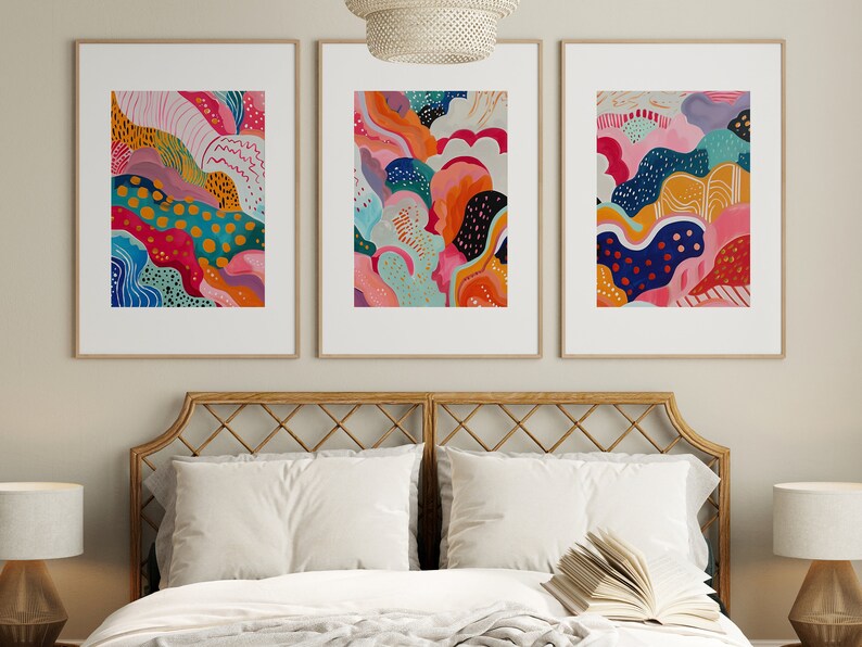 May include: Three framed abstract paintings with colorful, organic shapes and patterns. The paintings are in a modern style and feature a variety of colors, including pink, blue, green, yellow, and orange.