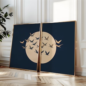 May include: Two framed prints with a navy blue background and a gold circle in the center. The circle is filled with a flock of gold birds flying in a circular pattern.