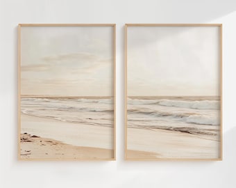 May include: Two framed prints of a beach scene with waves crashing on the shore. The prints are in a light wood frame and have a white background.