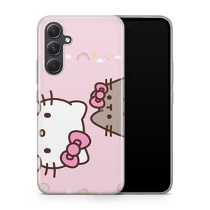 May include: A pink phone case with a Hello Kitty and Pusheen character design. The case has a cutout for a camera lens and a rainbow pattern.