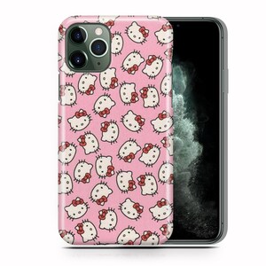 May include: A pink phone case featuring a repeating pattern of Hello Kitty faces. The case is designed for an iPhone 11 Pro.