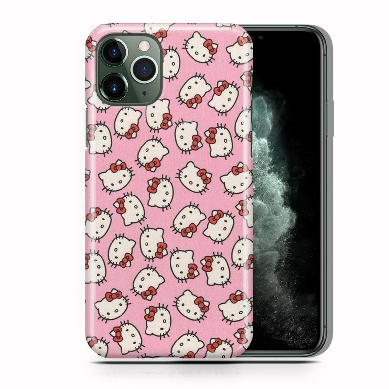 May include: A pink phone case featuring a repeating pattern of Hello Kitty faces. The case is designed for an iPhone 11 Pro.