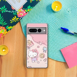 May include: A pink phone case with a Hello Kitty design. The case features Hello Kitty sitting on a pink and white floral background with a small mouse character. The case has a camera cutout and a pink border.